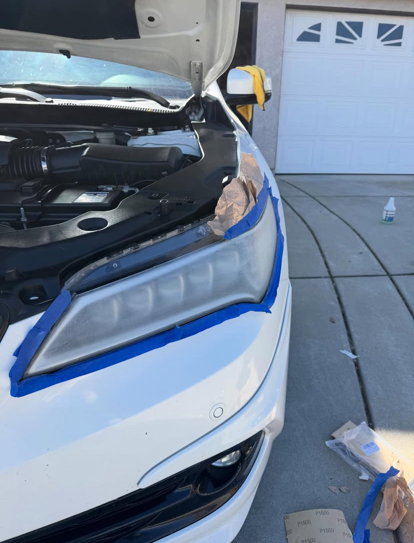 White Acura — right headlight before restoration, hazed lens